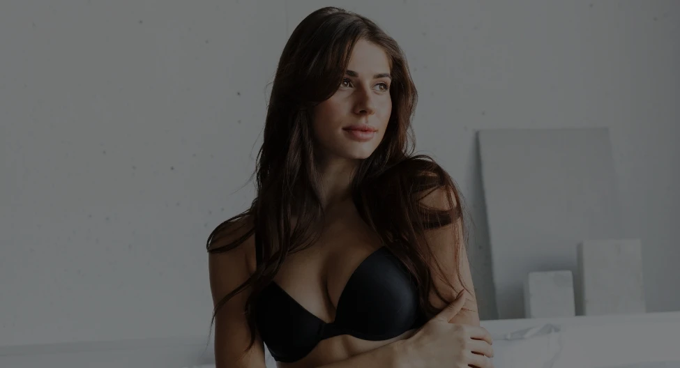 woman in black bra with arms crossed | Ottawa Plastic Surgery in Ottawa, Canada